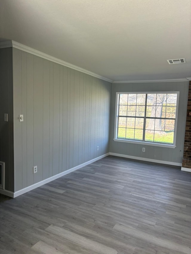 unfurnished room with wood-type flooring and crown molding