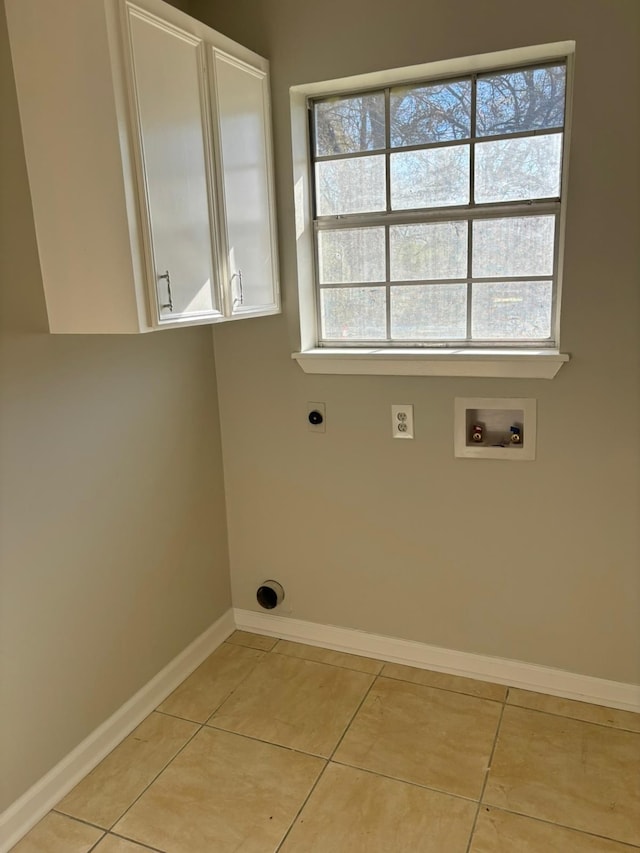 washroom featuring electric dryer hookup, light tile patterned flooring, cabinets, and hookup for a washing machine