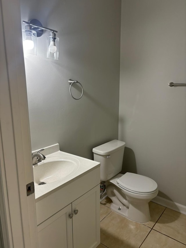 bathroom featuring toilet, vanity, and tile patterned floors