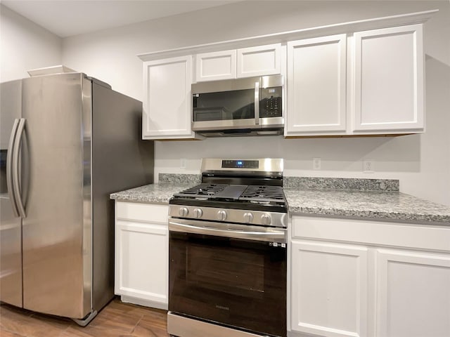 kitchen with stainless steel appliances and white cabinetry