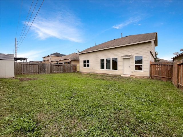 rear view of property featuring a yard