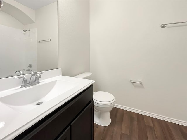 bathroom with hardwood / wood-style floors, vanity, and toilet