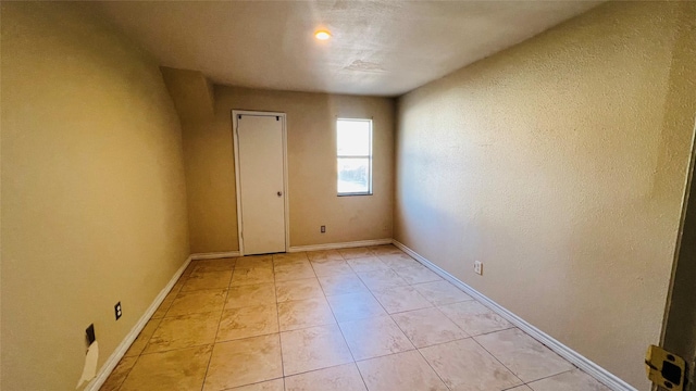 empty room featuring light tile patterned floors