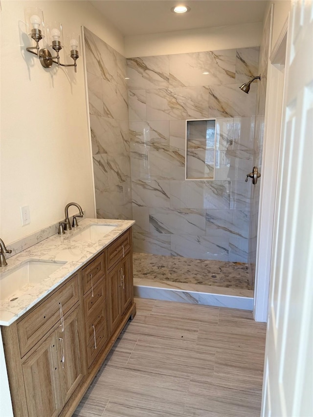 bathroom featuring vanity and tiled shower