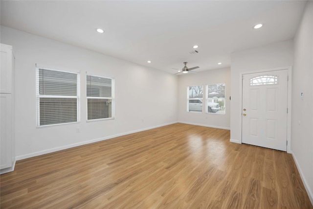 foyer entrance with ceiling fan and light wood-type flooring