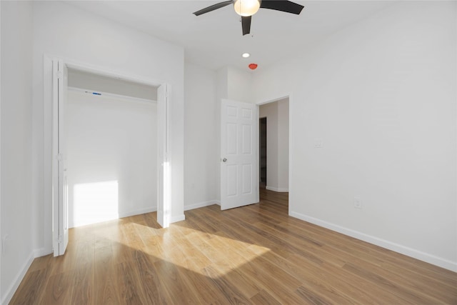 unfurnished bedroom with ceiling fan and light hardwood / wood-style flooring