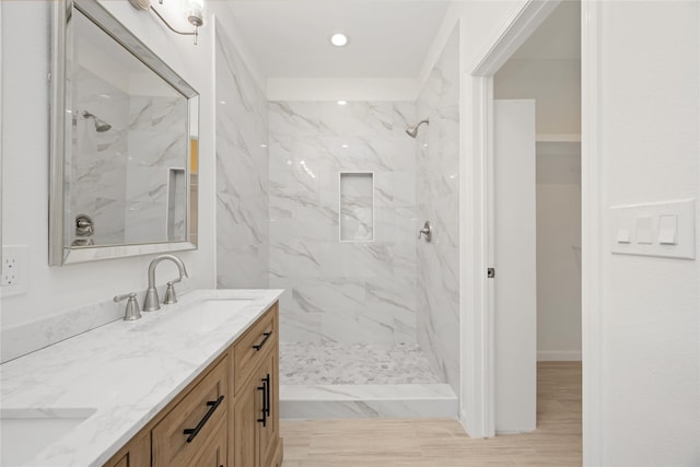 bathroom with vanity and tiled shower