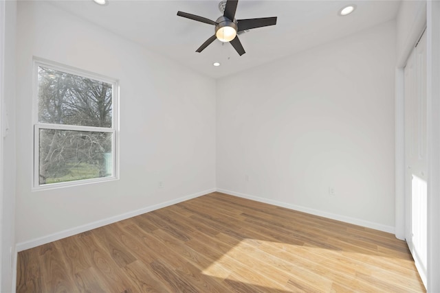 empty room featuring ceiling fan and light hardwood / wood-style flooring