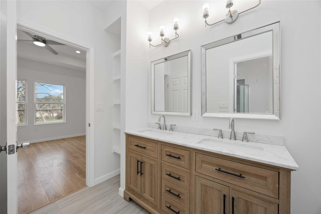 bathroom with vanity, hardwood / wood-style floors, and ceiling fan