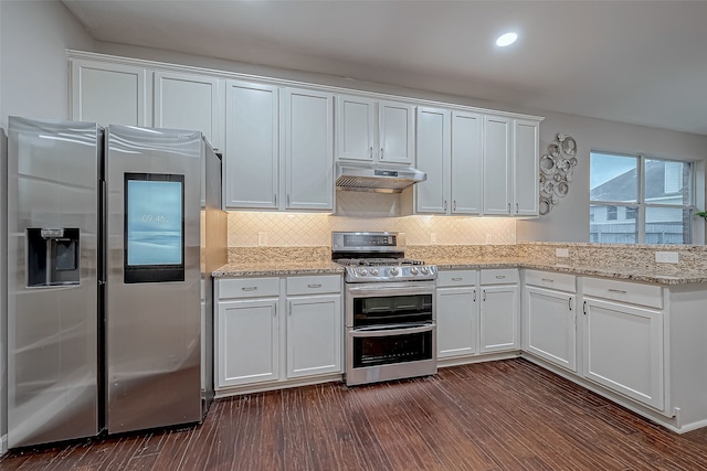 kitchen with decorative backsplash, white cabinetry, stainless steel appliances, and dark hardwood / wood-style floors