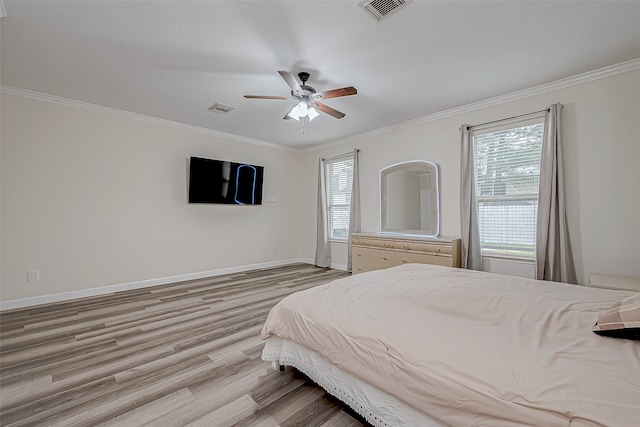 bedroom with ceiling fan, light hardwood / wood-style flooring, and ornamental molding