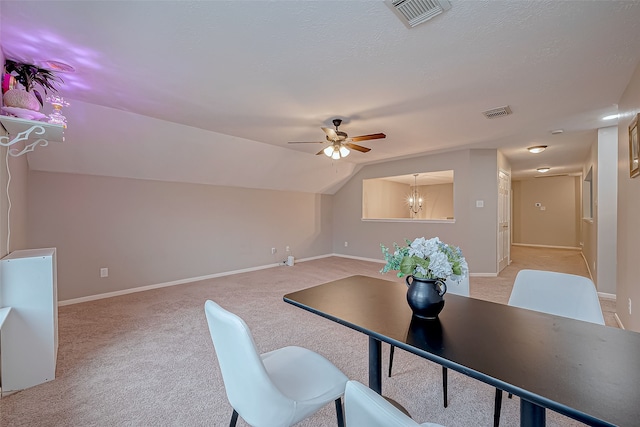 office area with light carpet, ceiling fan with notable chandelier, and vaulted ceiling