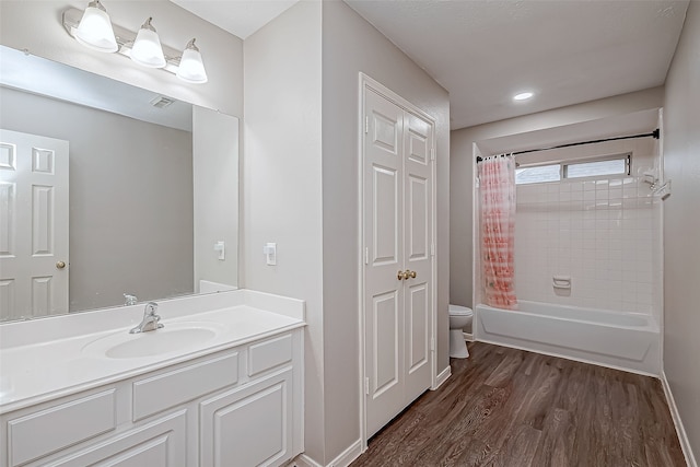 full bathroom with vanity, hardwood / wood-style flooring, toilet, and shower / bath combo with shower curtain