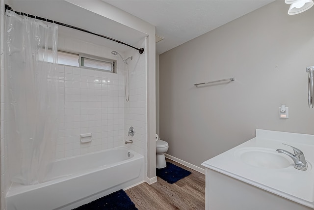 full bathroom with vanity, hardwood / wood-style flooring, toilet, and shower / bath combo with shower curtain