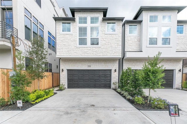 5636 Darling St, Houston, TX 77007 - view of front of home featuring an attached garage, driveway, fence, and stone siding