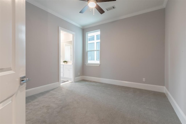 carpeted empty room with ceiling fan and ornamental molding