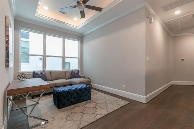 living room with hardwood / wood-style floors, ceiling fan, and ornamental molding