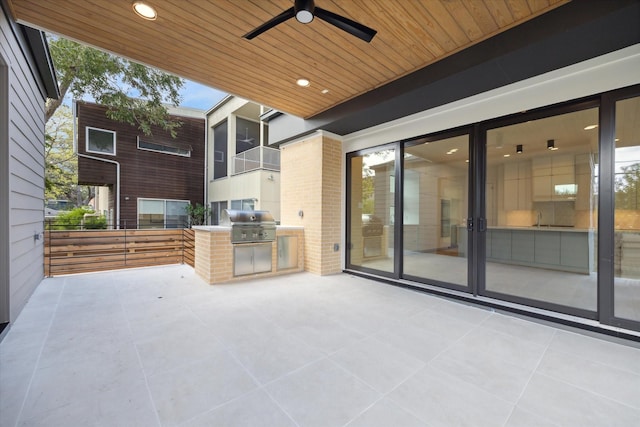 view of patio with ceiling fan, a grill, and exterior kitchen