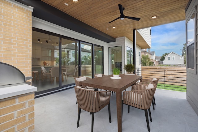 sunroom / solarium with wooden ceiling and ceiling fan