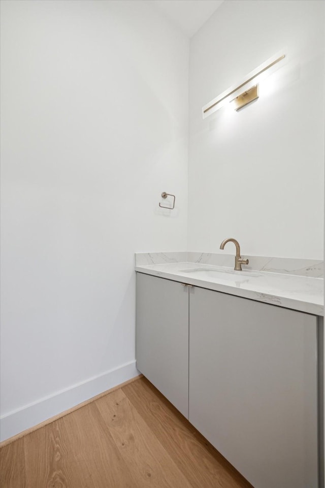 bathroom with vanity and hardwood / wood-style flooring