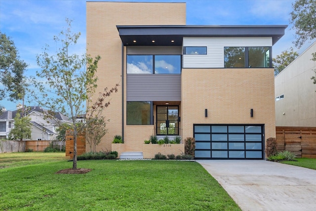 contemporary home featuring a garage and a front yard