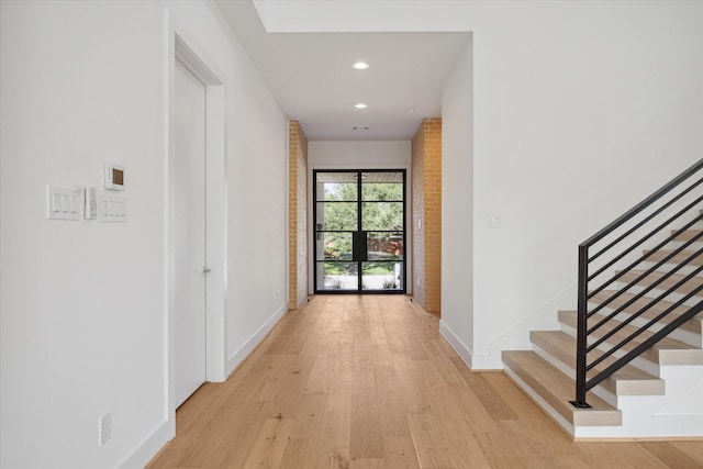 corridor with light hardwood / wood-style flooring