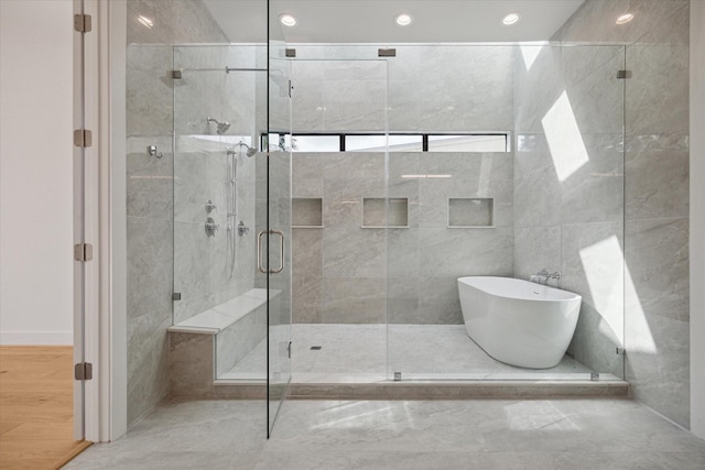 bathroom featuring separate shower and tub