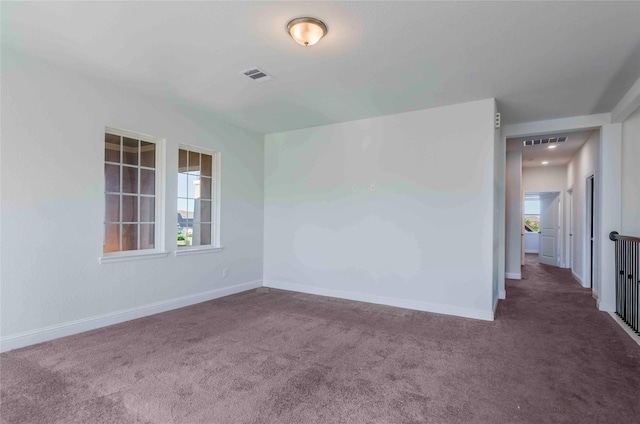 carpeted spare room with a healthy amount of sunlight