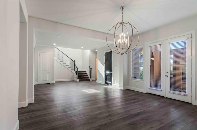 interior space with french doors, dark wood-type flooring, and a notable chandelier