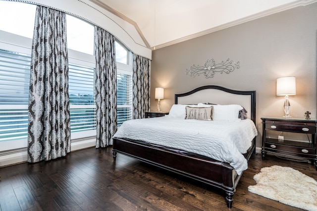 bedroom featuring vaulted ceiling, crown molding, dark hardwood / wood-style floors, and multiple windows