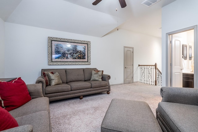 living room with lofted ceiling, ceiling fan, and carpet flooring