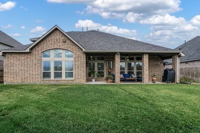 rear view of house with ceiling fan, outdoor lounge area, a yard, and a patio