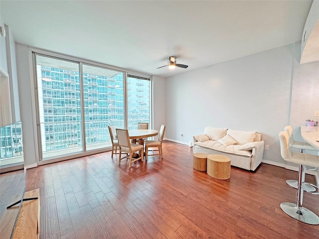 dining area featuring hardwood / wood-style flooring, ceiling fan, floor to ceiling windows, and a wealth of natural light