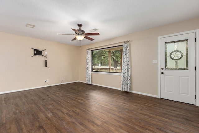 entrance foyer with dark wood-style flooring, visible vents, ceiling fan, a textured ceiling, and baseboards