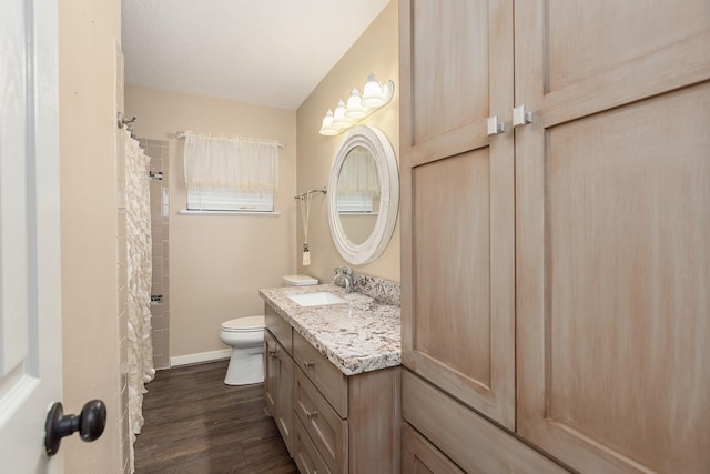 full bathroom featuring baseboards, vanity, toilet, and wood finished floors