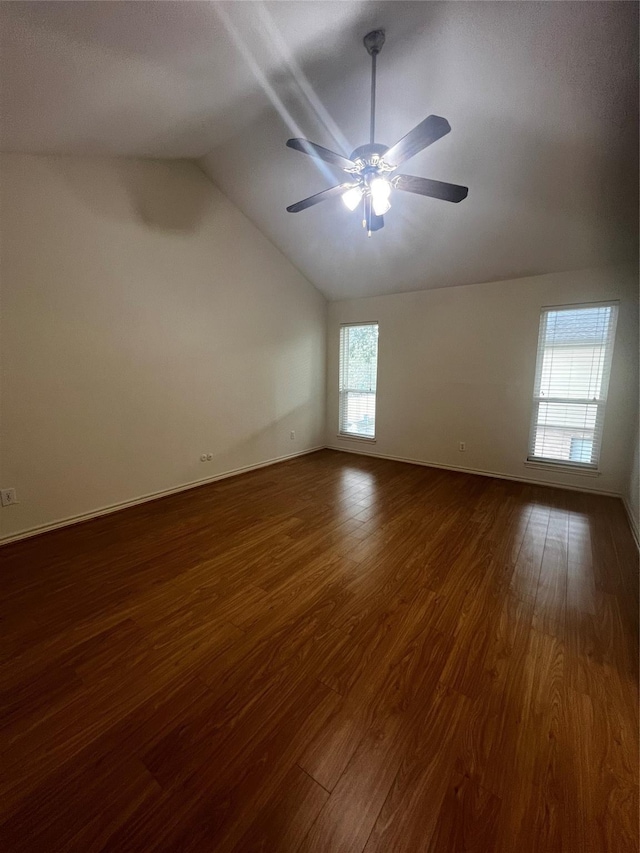 unfurnished room with ceiling fan, dark hardwood / wood-style flooring, a healthy amount of sunlight, and lofted ceiling