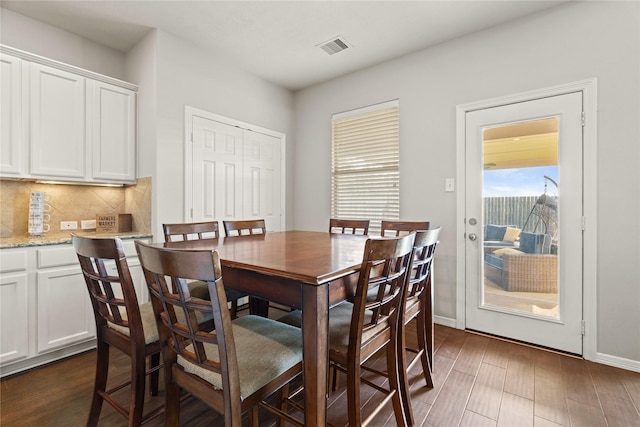 dining space featuring dark hardwood / wood-style flooring