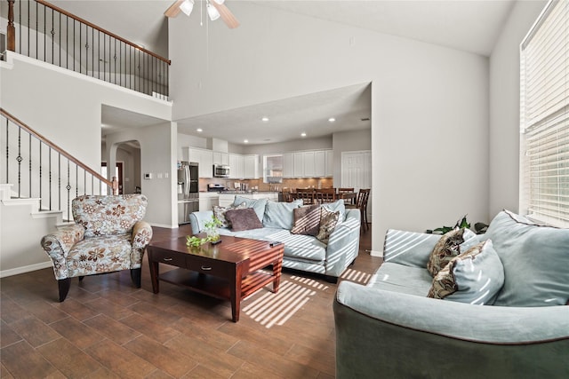 living room with high vaulted ceiling and ceiling fan