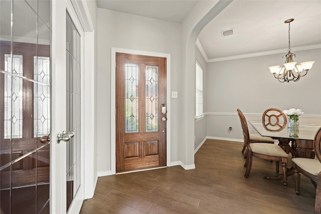 foyer entrance featuring french doors, an inviting chandelier, plenty of natural light, and ornamental molding