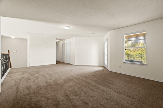 spare room with carpet floors and a textured ceiling