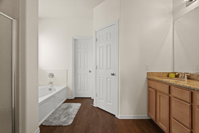 bathroom with a washtub and vanity