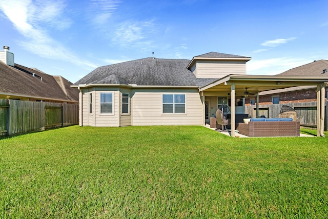 rear view of house with an outdoor living space, a patio, ceiling fan, and a lawn