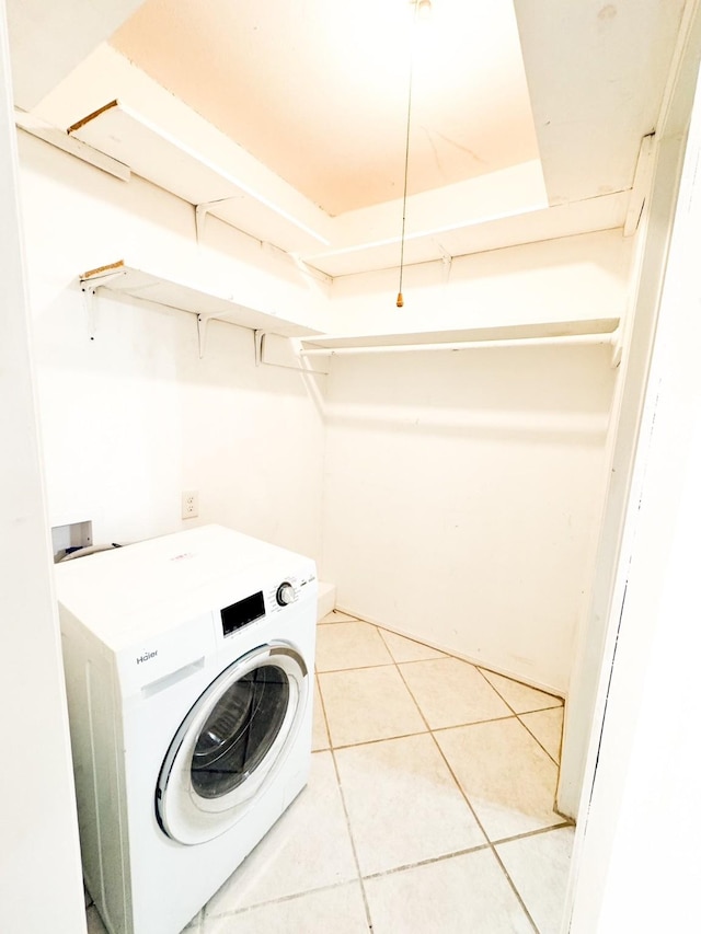 washroom with tile patterned flooring and washer / dryer