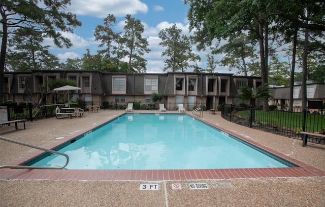 view of swimming pool featuring a patio area