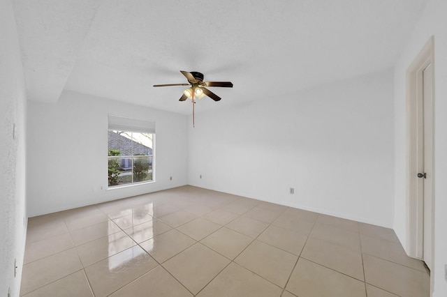 tiled empty room with ceiling fan