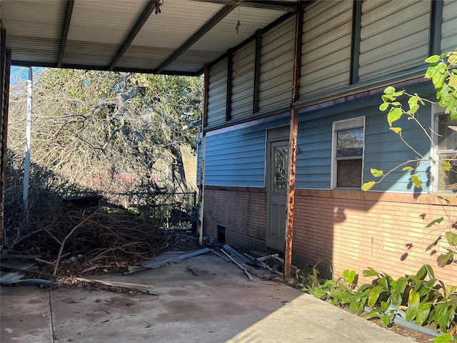 view of side of home with a carport