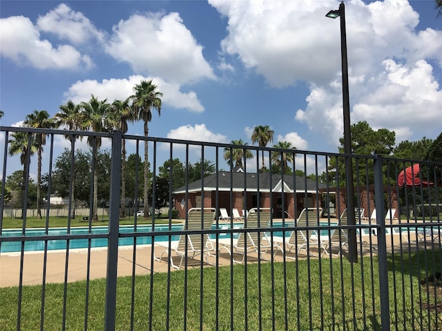 view of pool featuring a yard