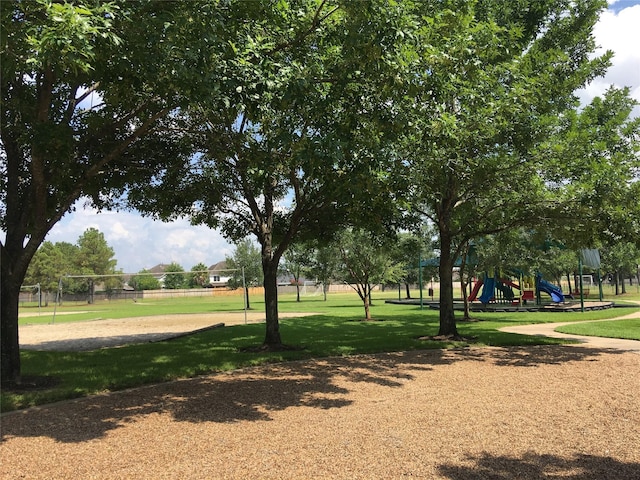 surrounding community with volleyball court, a yard, and a playground