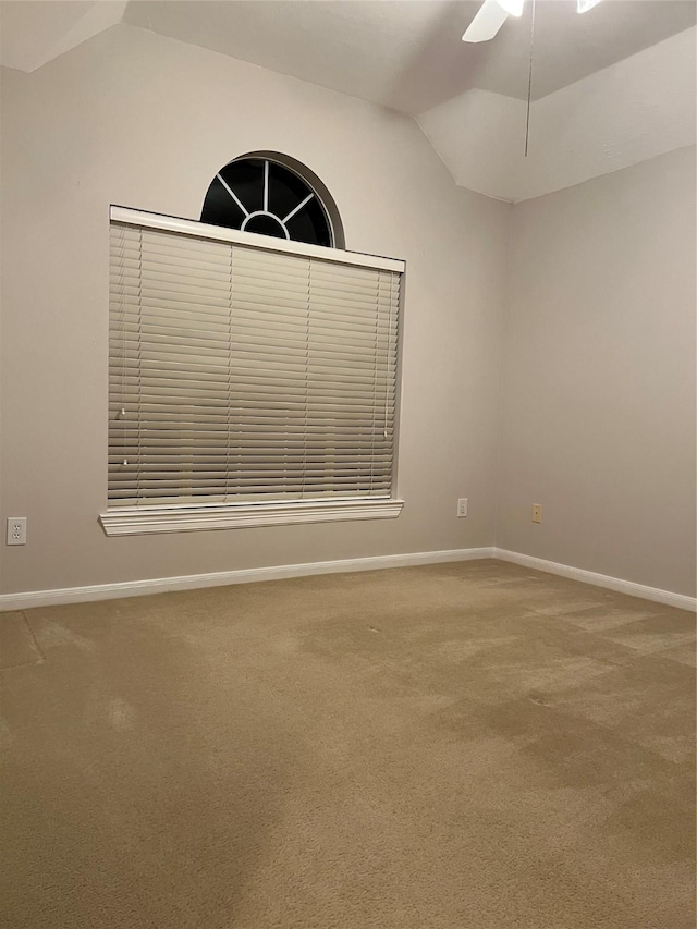 carpeted empty room with ceiling fan and vaulted ceiling