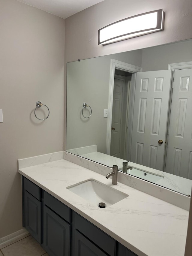 bathroom with tile patterned flooring and vanity